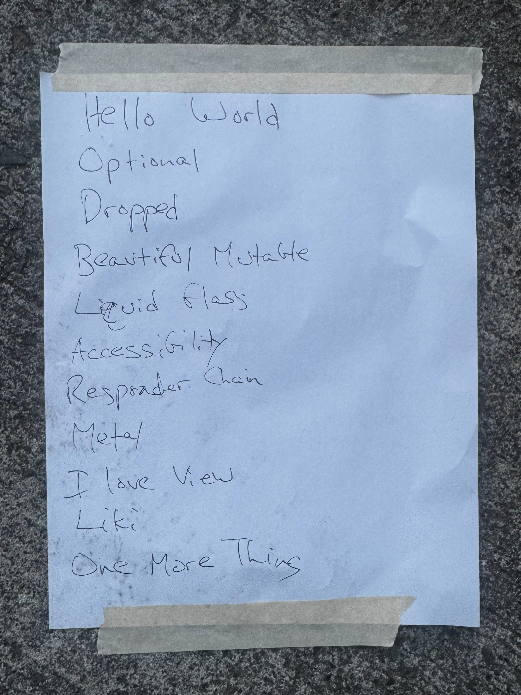 Handwritten setlist taped to the ground. Hello World, Optional, Dropped, Beautiful Mutable, Liquid Glass, Accessibility, Responder Chain, Metal, I Love View, Liki, One More Thing.