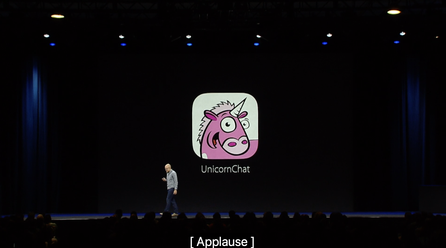 A live presenter on stage at WWDC 2016 in front of a large screen displaying the UnicornChat logo, with [Applause] captioned below.
